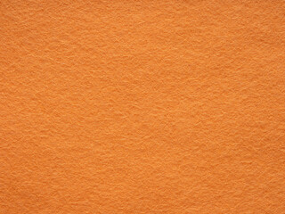 Orange felt texture. Saturated background for Christmas desktop, holiday New Year, xmas seasonal...