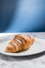 fresh croissant on the blue background