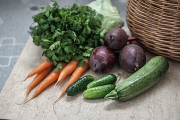 A straw basket and a harvest of vegetables from the market.
