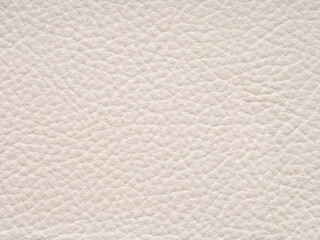 Beige leather texture sample. Genuine leather material closeup in light, soft tone. Background with copy space, top view. Backdrop blank skin effect for design, upholstered furniture, quality clothes.