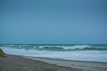 Angry ocean waves breaking on a empty sand beach. Kohe o Awa Beach, Pacific Coast, North Island, New Zealand