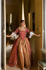 Lady in renaissance gown opening castle doors - obrazy, fototapety, plakaty