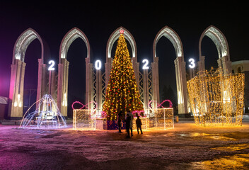 New Year festive architectural forms in front of the entrance to the city park of Almaty city in Kazakhstan