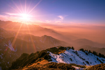 Wonderful view of numerous mountain ridges at sunset; magical atmosphere of a sunset in the highlands