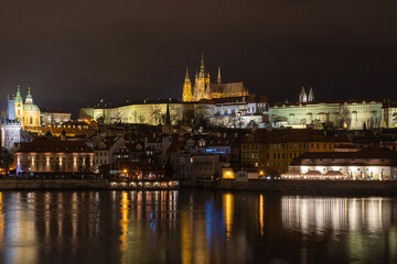 city castle at night. Views of Prague city at night, Charles Bridge in Prague with unrecognisable people on the move. Prague by night