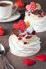 Mini Pavlova cakes with pomegranate, tangerines and grapes, Delicious dessert for Valentine's Day