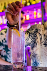 man bartender making cold gin tonic cocktail in bar