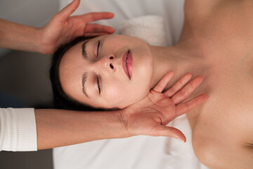 Obraz na płótnie Canvas Crop masseuse doing massage to client