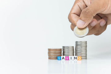 hand putting a coin on stacks of coin, money saving concept, financial and business growth concept, white background, copy space.