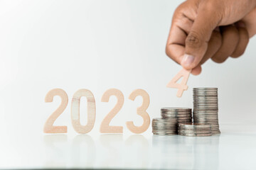 hand putting a coin on stacks of coin, money saving concept, financial and business growth concept, white background, copy space.