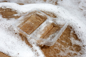 Plastic food container on the beach