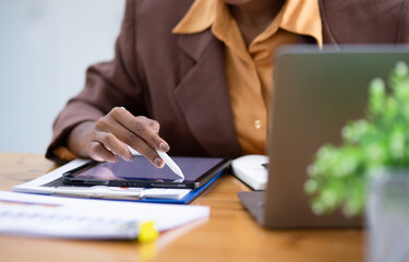 African American businesswoman holding digital tablet in hands.
