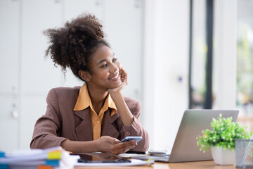 Young African American businesswoman working with pile of documents at office workplace, business finance and accounting concepts.