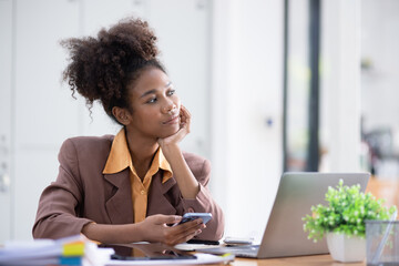 Young African American businesswoman working with pile of documents at office workplace, business finance and accounting concepts.