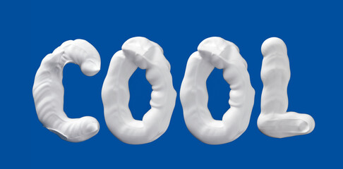 Cool word made of shaving foam letters on blue background