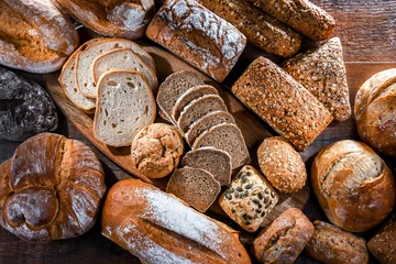 Deurstickers Assorted bakery products including loafs of bread and rolls © monticellllo