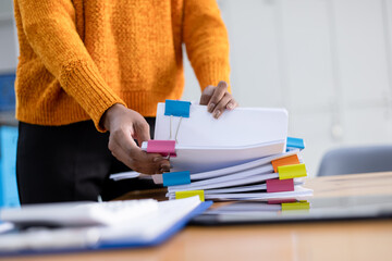 Hands of business working with Stacks of paper files for searching, document on folders papers at...