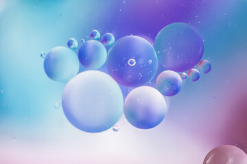 Abstract background in blue violet tones. Distortion in water with oil drops.