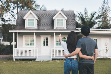 Asian love couple standing outside the new tiny house in countryside - 568378319