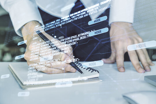 Double exposure of abstract programming language with hand writing in notebook on background with laptop, research and development concept