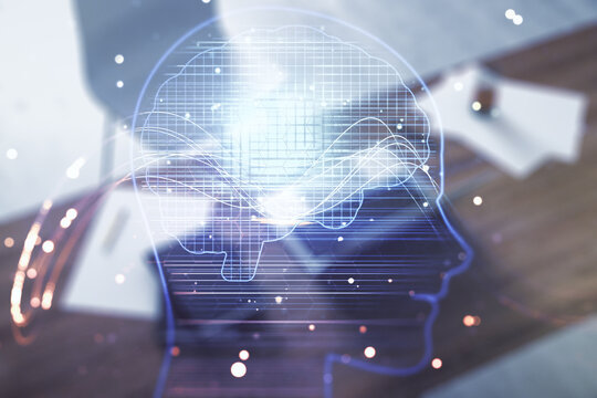 Double exposure of creative artificial Intelligence symbol and modern desktop with laptop on background. Neural networks and machine learning concept - Powered by Adobe