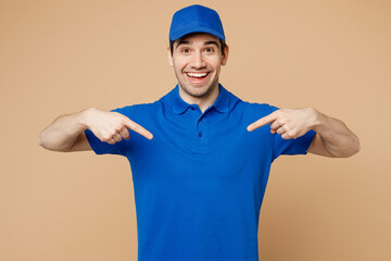 Fototapeta na wymiar Professional satisfied delivery guy employee man wear blue cap t-shirt uniform workwear work as dealer courier point index fingers on himself isolated on plain light beige background. Service concept.