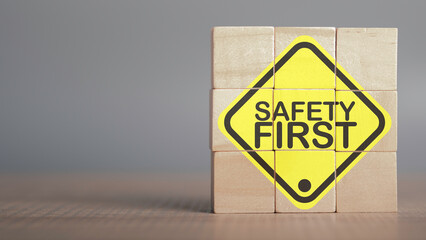Work safety concept. Safety first text yellow in wooden cube and copy spec. Safety first sign on virtual screen. Hazards, protections, regulations and insurance, Zero accidents, Protection dangerous. - obrazy, fototapety, plakaty
