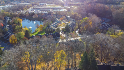 Lakeside apartment complex near industrial district with row of warehouses suburbs Rochester, Upstate New York, USA