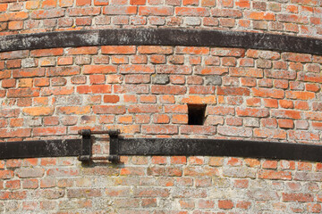 A closeup of an old stone furnace which is out of order
