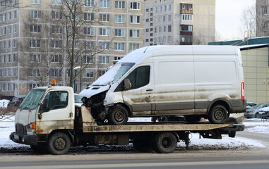 A tow truck transports a broken white minibus for repair, Iskrovsky Prospekt, St. Petersburg,...