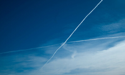Fototapeta na wymiar Aerial X Formation of Plane Contrails in a Clear Sky