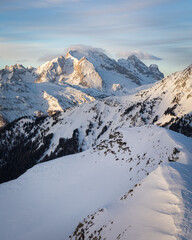 Fototapeta na wymiar winter sunrise over snow covered mountain - Marmolada in Dolomites 