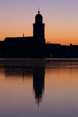 The Great Church in Deventer, the Netherlands, with reflection in the river IJssel at sunrise
