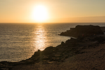 backlit seascape, beautiful golden sunset over the sea from the cliffs. El Cotillo, Fuerteventura, Canary Islands, Spain