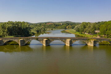 Drone photography of old antique bridge and river in Italy Tuscany