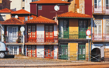 Porto, Portugal. Cosy street with traditional houses. Windows and doors. Sunny summer day. Residential district beautiful antique buildings