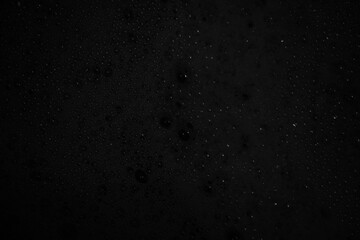 Black abstract background texture with bubbles.