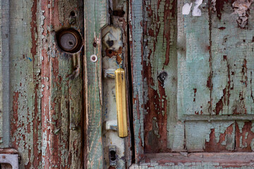 old battered wooden door handle and lock.