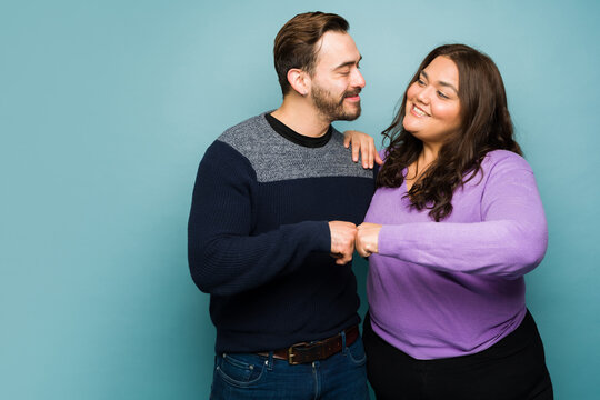 Cheerful boyfriend and girlfriend doing a fist bump