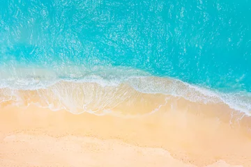 Gordijnen Summer seascape beautiful waves, blue sea water in sunny day. Top view from drone. Sea aerial view, amazing tropical nature background. Beautiful bright sea waves splashing and beach sand sunset light © icemanphotos