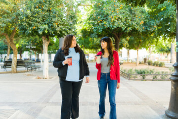 Best friends talking and taking a relaxing walk in the park