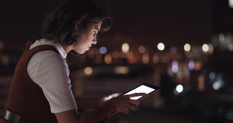 Woman, tablet and balcony at night in city for digital marketing, online networking or planning web strategy. Creative website design, designer working on tech device and relax on building rooftop