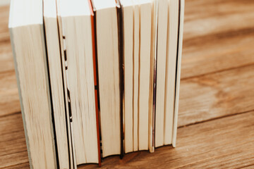 A stack of books stand on the tables, stacked in the frame.