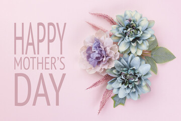 Happy Mother's Day Pastel Blue and Pink Colored Background. Flat lay floral greeting card with beautiful silk flowers.