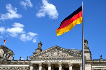 view on the german parliament Reichstag in Berlin with german flag