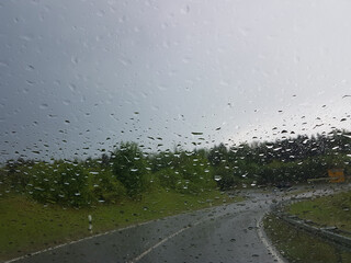 car ride in rainy weather at curvy road