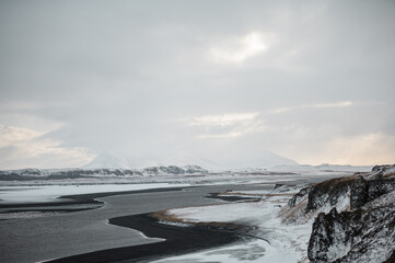 Snowy fjord landscape in Iceland with calm water