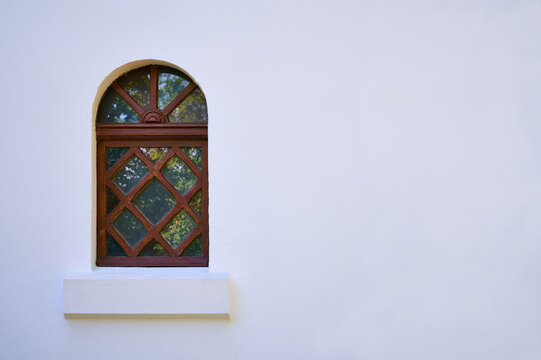 Old wooden window on white wall with space for text or image.