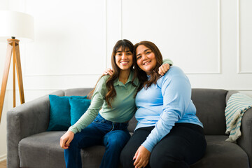 Relaxed women friends sitting on the sofa at home