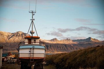 Landscape of fishing village in iceland with a boat as the main subject and blurred background